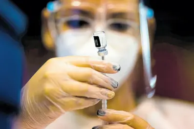  ?? AP ?? FILE - A nurse prepares a dose of the Pfizer COVID-19 vaccine at the Tomas Dones Coliseum, in Fajardo, Puerto Rico, Jan. 8, 2022.