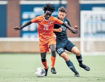  ?? Jeffrey A. Camarati, University of North Carolina Athletic Communicat­ions ?? Philip Mayaka, left, of the Clemson Tigers was drafted by the Rapids at No. 3 overall in the MLS SuperDraft.