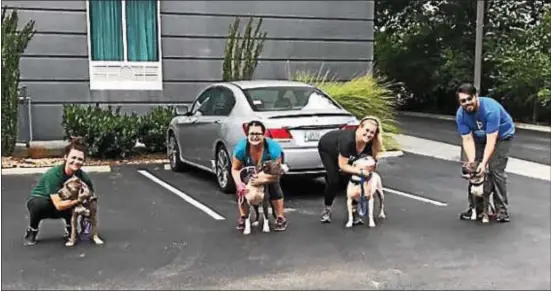  ?? SUBMITTED PHOTO ?? Providence Animal Center workers offer hugs to some of the dogs they rescued from flooding conditions from Harvey in Texas.