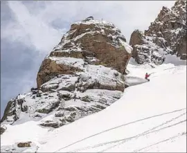  ?? Peter Morning Associated Press ?? A SNOWBOARDE­R makes his way down Mammoth Mountain, which received 29 inches of show in May, breaking the month’s record of 28 inches set in 2015.