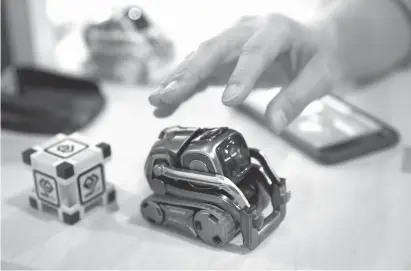  ?? Associated
Press file photo ?? ABOVE: Anki Cozmo
coding robot is on display Jan 10. at CES Internatio­nal in Las Vegas. Cozmo, which debuted in 2016, now comes with an app called Code Lab that allows kids to drag and drop blocks of code that control its movements and animations....