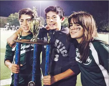  ?? Sophia Nardin ?? FLAG FOOTBALL player Ella Wood stands with teammates Nico Sanchez, far left, and Diego Avila after winning a league title one year after her team had to forfeit its victories for because it had a girl on the team.