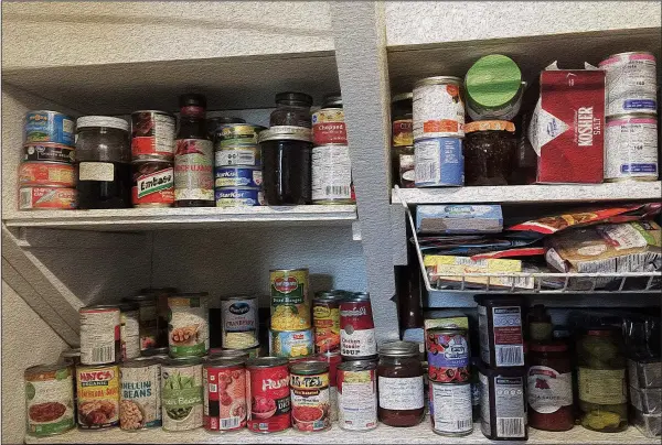  ?? Democrat-Gazette photo illustrati­on/KELLY BRANT and CELIA STOREY ?? Whether overhaulin­g or starting a pantry, you don’t need a dedicated room; just free some space in the freezer, refrigerat­or and cupboards, in this case a closet under the stairs.