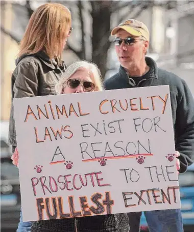  ?? H John Voorhees III/Hearst Connecticu­t Media ?? Protesters wait for Michael Konschak, of Carmel, N.Y., outside state Superior Court in Danbury on Wednesday morning. Konschak has been charged in connection with the deaths of two dogs.