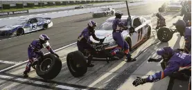  ??  ?? Crew members hustle to service Denny Hamlin’s car during a pit stop Sunday. Hamlin led 49 laps and now leads the Cup Series race with four wins on the season.