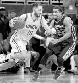  ?? SAM GREENWOOD/GETTY IMAGES ?? Evan Fournier, left, came off the bench for the first time this season in the Magic’s loss to the Charlotte Hornets on Friday. He scored 13 points through the first three quarters.