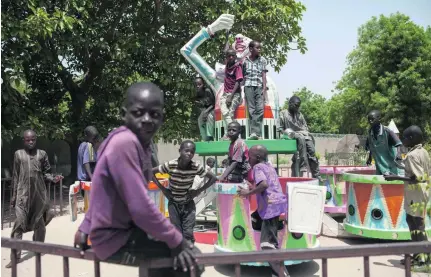  ?? Florian Plaucheur / AFP ?? Children orphaned by Boko Haram play in an abandoned amusement park in Maiduguri, Nigeria, last month.