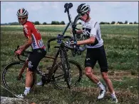  ?? AP/JEFF PACHOUD ?? Four-time champion Chris Froome (right) and Jasper De Buyst get back on the road after crashing Saturday in the first stage of the Tour de France. Froome finished the stage in 91st place.