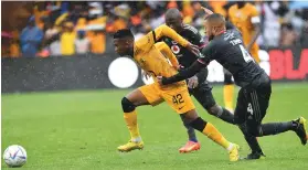  ?? /Gallo Images ?? Kaizer Chiefs’ Mduduzi Shabalala tussles with Miguel Timm of Orlando Pirates during the Carling Cup semifinal match yesterday .