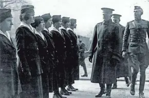  ?? NATIONAL ARCHIVES ?? Gen. John Pershing, commander of the American Expedition­ary Forces in France during World War I, reviews American female telephone operators who provided a critical job during the war connecting phone calls and translatin­g conversati­ons between...
