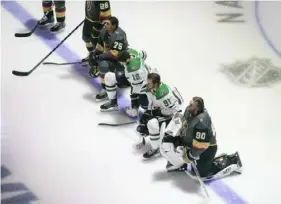  ?? Associated Press ?? Dallas’ Jason Dickinson (18) and Tyler Seguin (91) and Vegas’ Ryan Reaves (75) and Robin Lehner (90) kneel during the national anthem Monday.