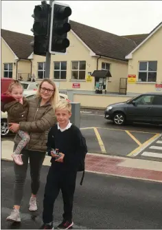  ??  ?? Lara Yeomans with her daughter, Kylah, and brother, Billy Majewski at the new pedestrian crossing.