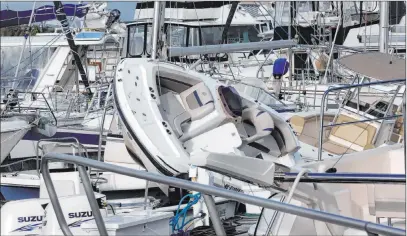  ?? Gerry Broome The Associated Press ?? Boats shuffled into wreckage at a marina in Southport, N.C., on Tuesday after being ravaged by Hurricane Isaias.