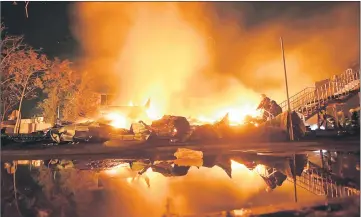  ?? — AFP photo ?? Firefighte­rs extinguish a fire at a children’s camp in Odessa.