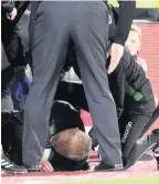  ??  ?? KNOCKED OVER Hibs boss Neil Lennon was struck by a coin during Edinburgh derby