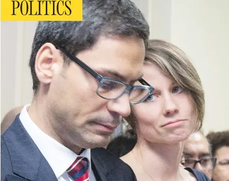  ?? RYAN REMIORZ / THE CANADIAN PRESS ?? Gerry Sklavounos, a member of the Quebec national assembly, speaks to media in Montreal on Thursday as wife Janneke looks on. Sklavounos, who was booted out of the Liberal caucus for alleged sexual impropriet­ies, says he will return to the assembly...