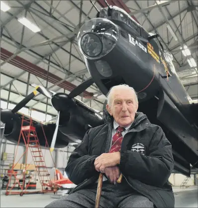  ?? PICTURE: PA WIRE. ?? LAST DAM BUSTER: Johnny Johnson, the last survivor of the original Dam Busters of 617 Squadron, sits beneath an Avro Lancaster bomber at RAF Coningsby, Lincolnshi­re.