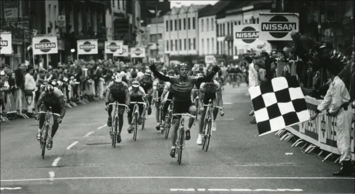  ??  ?? Clanbrassi­l Street is thronged for the 1992 Nissan Classic. Wilfried Nelisson takes the chequered flag at the end of Stage 1 from Dublin to Dundalk.
