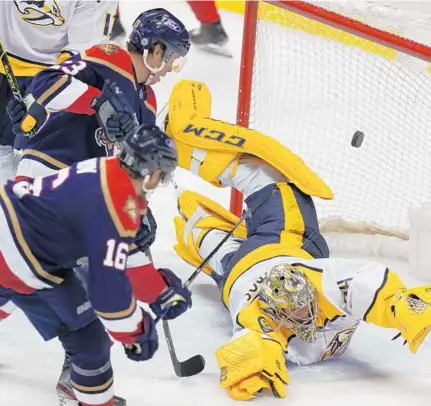  ?? WILFREDO LEE / AP ?? Florida Panthers center Aleksander Barkov scores against Nashville Predators goaltender Juuse Saros in a 2-0 win Saturday.