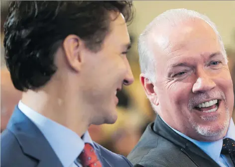  ?? DARRYL DYCK/THE CANADIAN PRESS ?? B.C. Premier John Horgan, right, and Prime Minister Justin Trudeau celebrate the announceme­nt Tuesday in Vancouver that Shell and its joint-venture partners would fund LNG Canada, the biggest private-sector investment in Canada’s history.