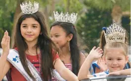  ?? MARTA LAVANDIER/AP ?? Members of the Florida Internatio­nal Girl pageant group wave during a Fourth of July parade Monday in Plantation, one of many holiday events across the U.S.