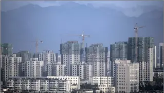  ?? PHOTO: BLOOMBERG ?? Residentia­l buildings stand under constructi­on in Qinhuangda­o, Hebei province, China. But outbound property deals are heavily affected by capital restrictio­ns that have been introduced.