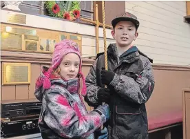  ?? SPECIAL TO THE EXAMINER ?? Zoey and Kaiden, neighbourh­ood friends of St. Matthew-St. Aidan Anglican Church, helped in the tolling of the bell 100 times on Nov. 11.