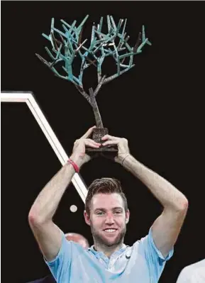  ?? REUTERS PIC ?? Jack Sock celebrates with the trophy after defeating Filip Krajinovic in the final of the Paris Masters on Sunday.