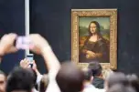  ?? —AFP ?? In this file photograph Visitors take pictures in front of The Mona Lisa after it was returned at its place at The Louvre Museum in Paris.