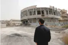  ?? — AFP ?? A member of the first response team tours the courtyard of the National Hospital building in the northern Syria city of Raqa on Saturday.