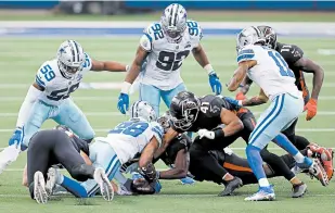  ?? TOM PENNINGTON/GETTY ?? C.J. Goodwin recovers an onside kick with 1:48 left in the Cowboys’ victory over the Falcons on Sunday.