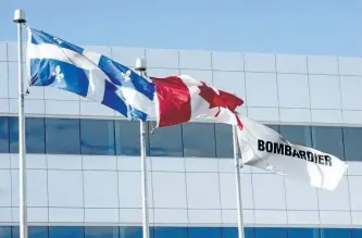  ?? THE CANADIAN PRESS FILES ?? Flags fly outside the Bombardier CSeries plant, on Sept. 28, in Mirabel, Que.
