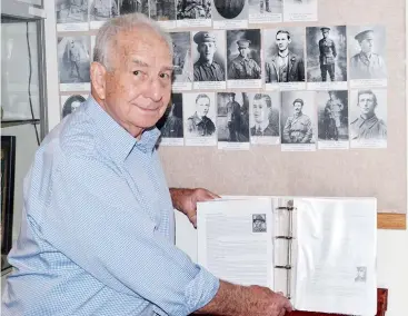  ??  ?? Ron Blair browses through the book “Courage and Sacrifice” that he has compiled detailed the World War 1 service of all those from the municipali­ties that now form Baw Baw shire. The book can be viewed at the Warragul RSL.