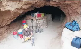  ?? U.S. Navy courtesy of Steve Schwartz ?? RENE VELLANOWET­H shows a cave on San Nicolas Island where a Native American woman is believed to have lived. The Navy ordered a halt to the dig.