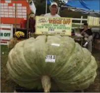  ?? SUSAN JUTRAS VIA AP ?? Joe Jutras stands with his world record breaking, 2,118-pound squash, following a weigh-in at Frerichs Farm in Warren, R.I. Jutras has become the first grower in the world to achieve a trifecta in the three most competitiv­e categories in the hobby of...