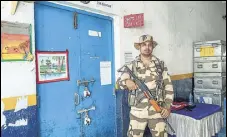  ?? PTI ?? A security official stands guard outside a strongroom in West Midnapore district on Friday.