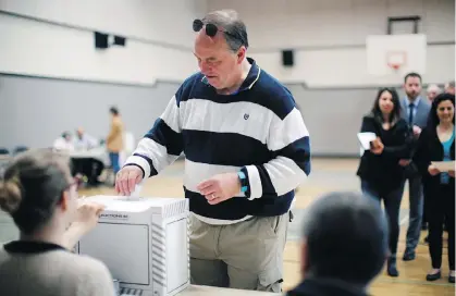  ?? CHAD HIPOLITO/THE CANADIAN PRESS ?? B.C. Green party Leader Andrew Weaver casts his ballot at Gordon Head Middle School in Victoria on Tuesday. Permanent residents living in Canada — including 60,000 in Vancouver — can’t vote in federal, provincial or municipal elections.