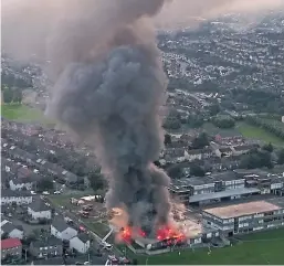  ??  ?? The thick smoke rises high into the sky from the blazing school in this drone image sent by Dan Casey.