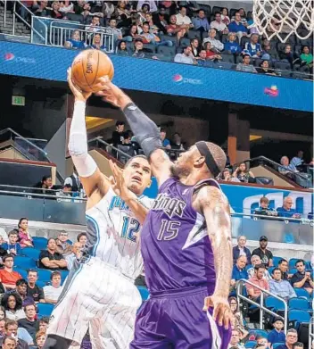  ?? JOSHUA C. CRUEY/ORLANDO SENTINEL ?? Forward Tobias Harris, left, shoots over Sacramento’s DeMarcus Cousins. Harris scored a game-high 23 points.