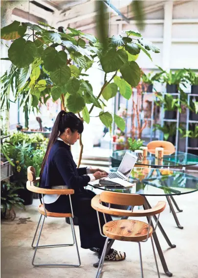  ?? PAUL BARBERA VIA AP ?? Artist Takahashi Kiroko works on the second floor of her Tokyo studio while surrounded by plants.