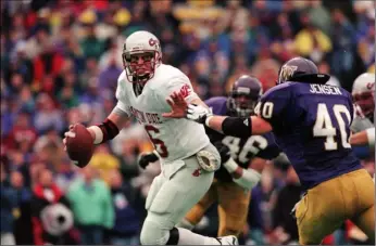  ??  ?? In this Nov. 22, 1997, file photo, Washington State quarterbac­k Ryan Leaf is pressured by Washington in the NCAA college football Apple Cup game, in Seattle. AP PHOTO