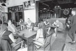  ??  ?? The lunch crowd March 23 at Tap 42 Craft Kitchen & Bar at the Tower Shops in Davie.