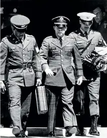  ??  ?? Flanked by two military policemen carrying his personal belongings, Lieutenant William L Calley Jr, of Miami, Florida, leaves court at Fort Benning, Georgia after he was sentenced to life imprisonme­nt for his role in the massacre at My Lai.