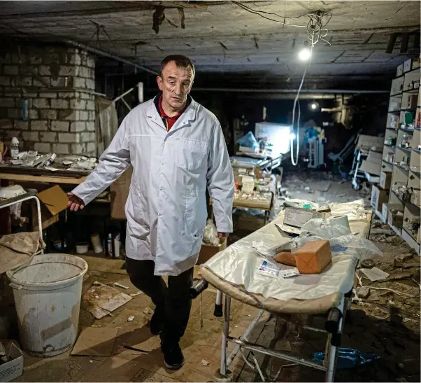  ?? ?? Selfless: Yuriy Kuznetsov in his hospital basement. Far left, the shattered apartment block