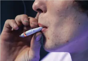  ??  ?? A customer smokes a marijuana and tobacco joint at Frankie Sports Bar and Grill in Olympia, Washington, in the US. Ohio voters on Tuesday said ‘no’ to a bill that would legalise recreation­al marijuana, local media projection­s indicated. Picture: REUTERS