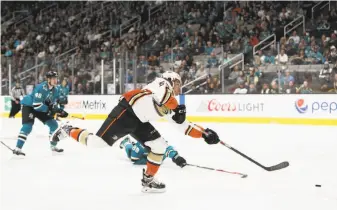  ?? Ezra Shaw / Getty Images ?? Anaheim rookie Max Comtois unleashes a first-period shot that produced his first career NHL goal and started the Ducks on their way to a season-opening win over the Sharks at SAP Center.