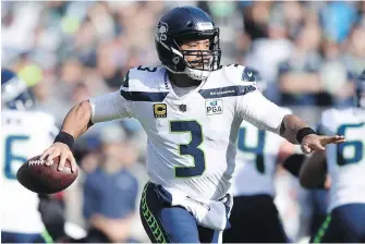  ?? MIKE McCARN, AP ?? Through 12 games, Seattle Seahawks quarterbac­k Russell Wilson has 29 touchdowns and five intercepti­ons. He has thrown at least two TD passes in eight straight games and 11 of 12 this season.