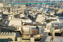  ?? CHRISTIAN MURDOCK/THE GAZETTE 2016 ?? A soldier walks past M1 Abrams tanks at Fort Carson in Colorado Springs, Colo. The U.S. is close to sending some high-tech tanks to Kyiv, officials say.