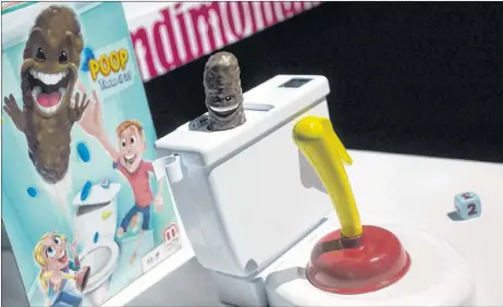  ?? AP PHOTO ?? Flushin’ Frenzy from Mattel is on display at Toy Fair in New York. Reflexes and a toilet plunger combine to make a plastic poop fly.