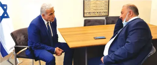  ?? (Courtesy Lapid’s office) ?? YESH ATID leader Yair Lapid meets with the head of Ra’am, Mansour Abbas.
